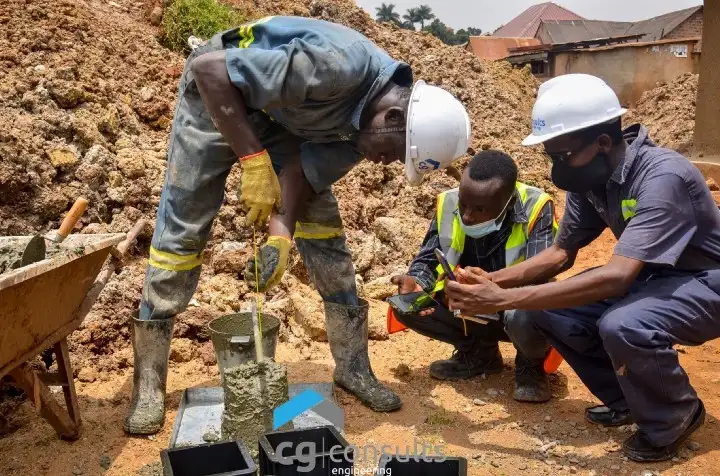 Checking for concrete slump at Drainage Improvement Works Project in Kawempe, Kampala City by CG Engineering Consults Staff and a member of the Consultant’s team.